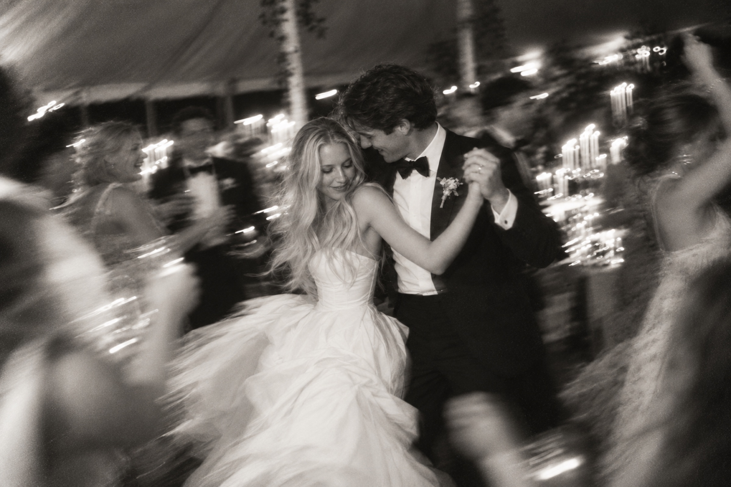 Newlyweds dancing at their candlelit reception